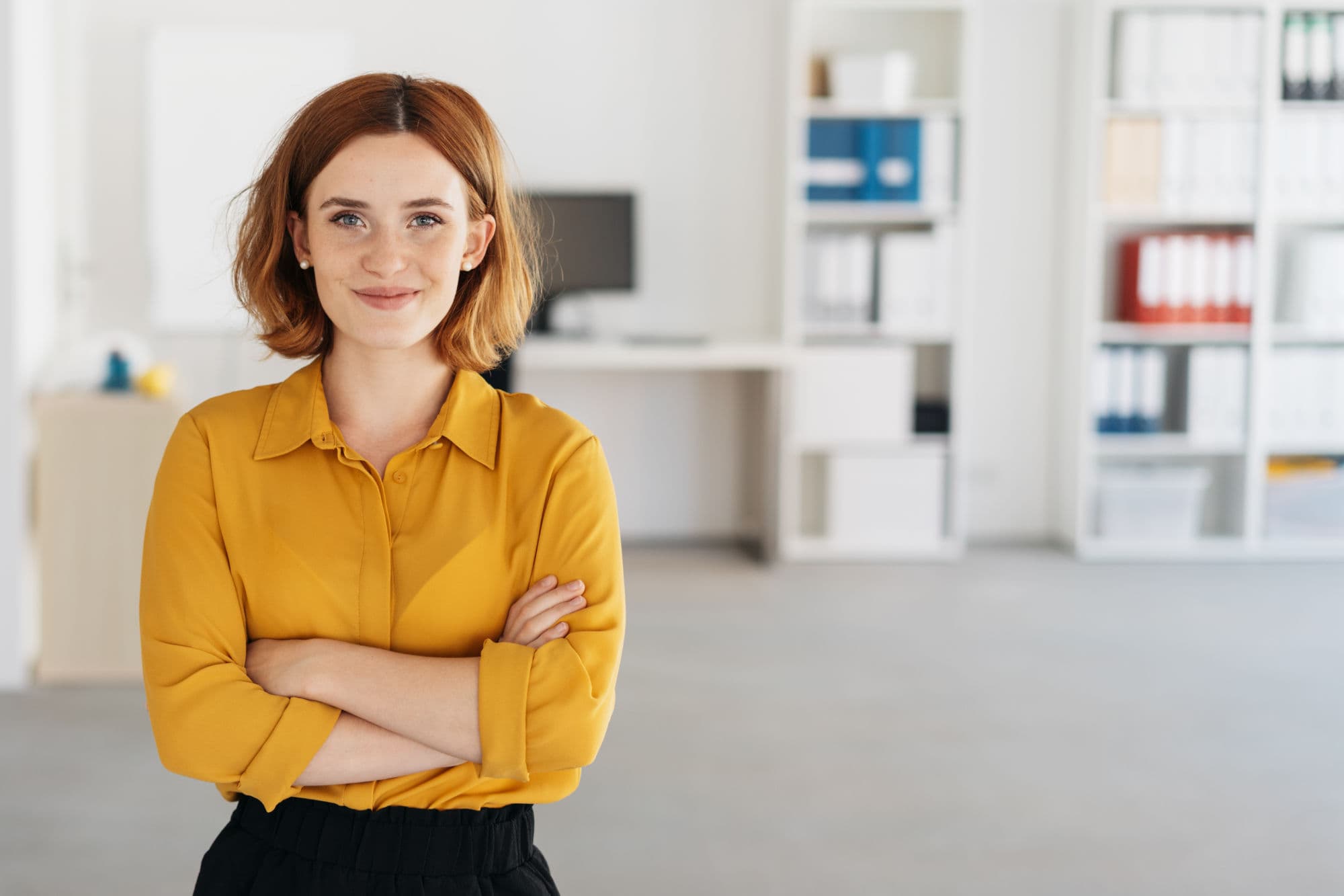 A Womin is standing in an office environment